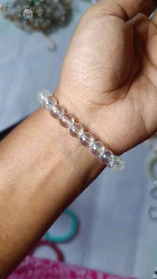 Clear beaded white bracelet worn on wrist showcasing simple and elegant design by Glitter Mafia