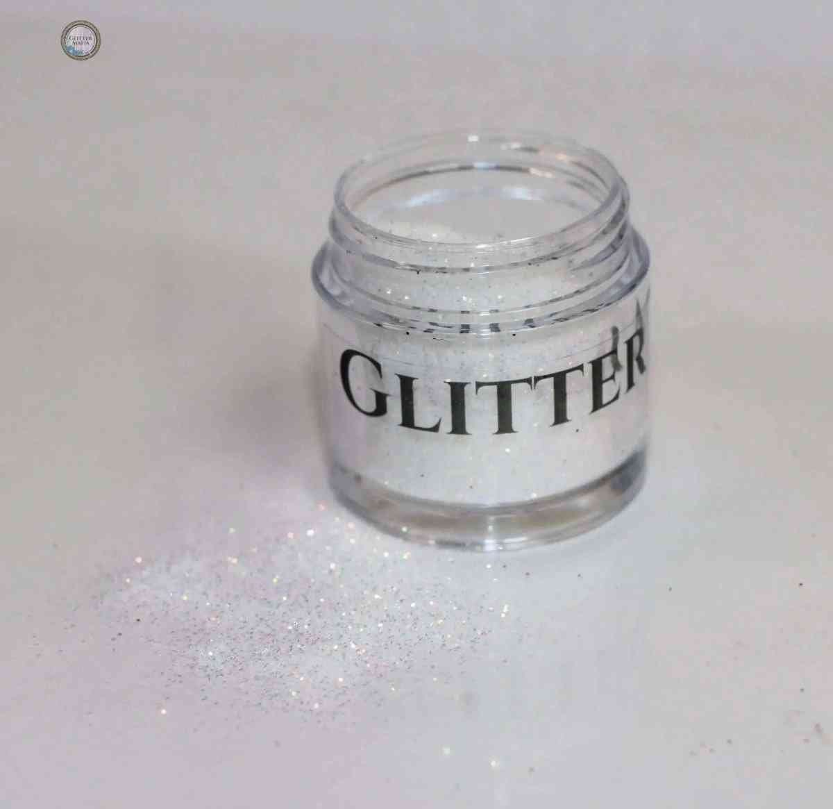 Glitter Mafia Glimmer Loose Glitter in clear container with shimmering white sparkle spilled on surface