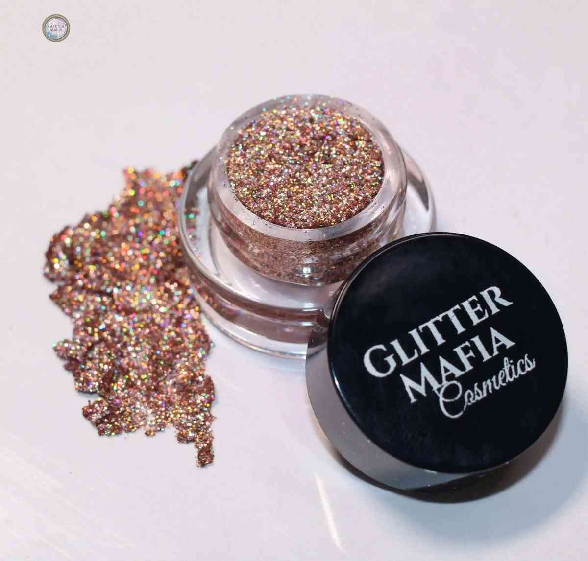 Midas Touch Mini Pressed Glitter by Glitter Mafia in clear jar with black lid and spilled glitter