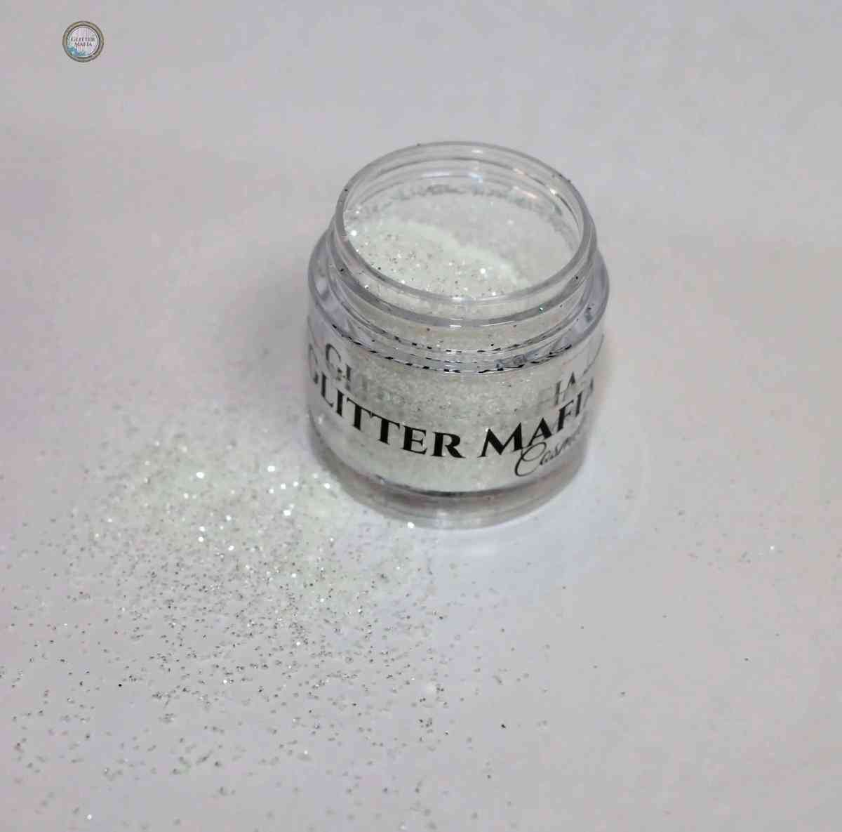 Glitter Mafia jar of Diamond Loose Glitter with sparkling white glitter spilled on white surface