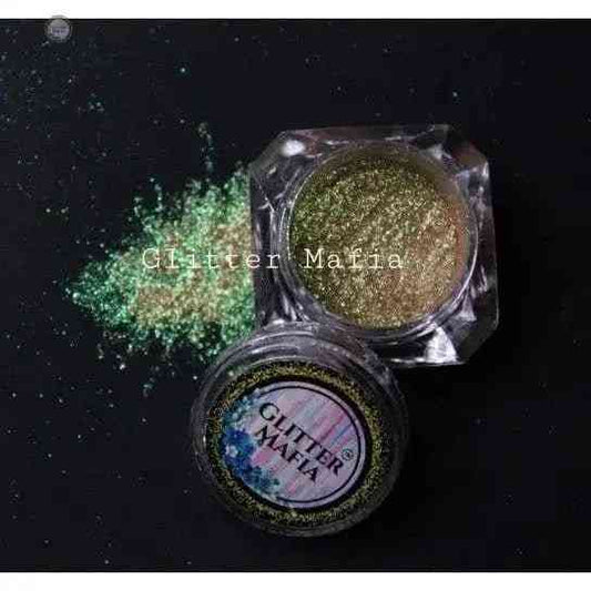 Tiana Lustrous Pigment by Glitter Mafia in clear container with green glitter powder spilled on black background