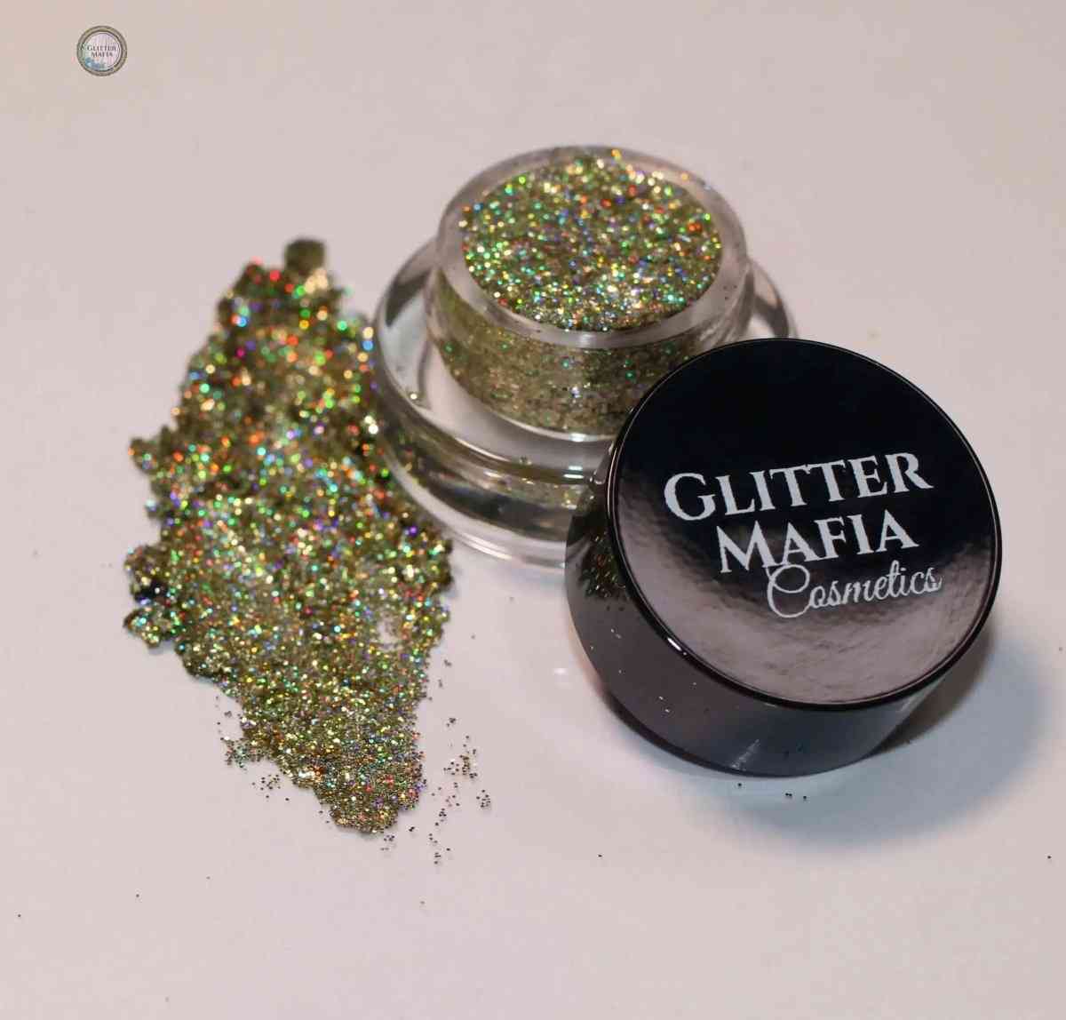 Glitter Mafia Luna Pressed Glitter in a small clear jar with black lid and sparkling gold shimmer