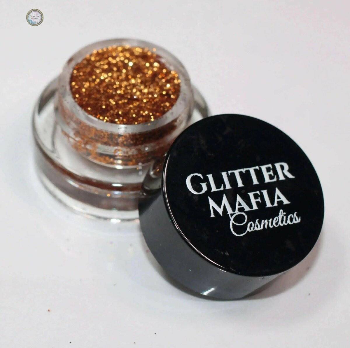 Glitter Mafia Marigold Pressed Glitter in small clear container with black lid for cosmetics