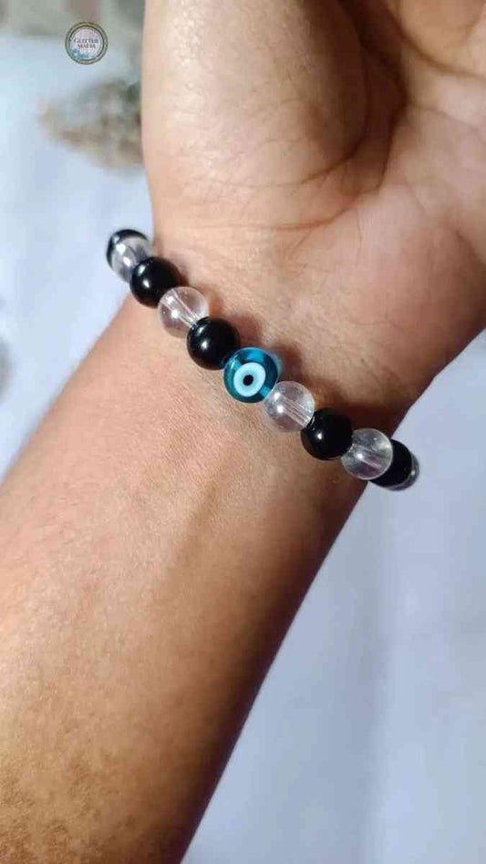 Glitter Mafia evil eye bracelet with black and clear beads on a wrist