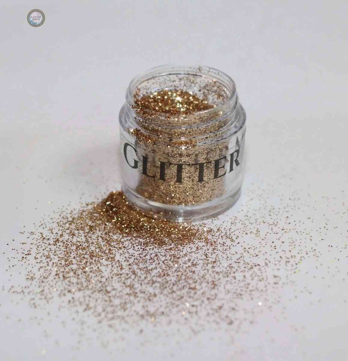 Glitter Mafia Nebula Loose Glitter in a clear jar with gold sparkles spilled around it