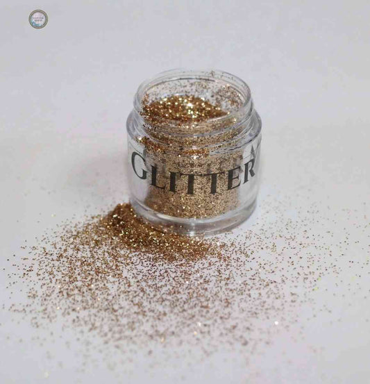 Glitter Mafia Nebula Loose Glitter in a clear jar with gold sparkles spilled around it