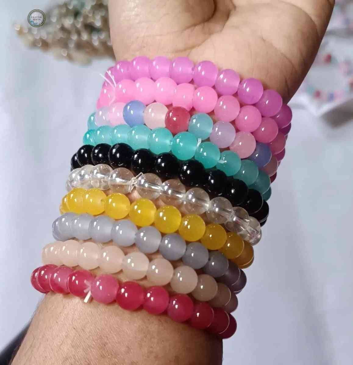 Colorful set of 10 piece bracelet by Glitter Mafia featuring round beads in multiple vibrant colors