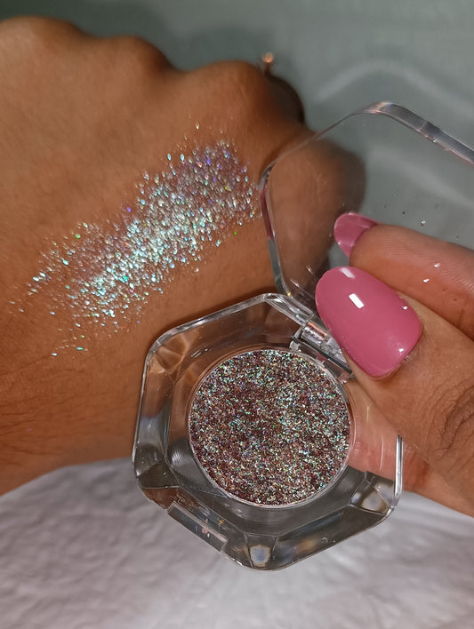 Glitter Mafia loose glitter pot and swatch on hand Galaxy Ember- Deep mauve brown with cosmic green and pink flips.