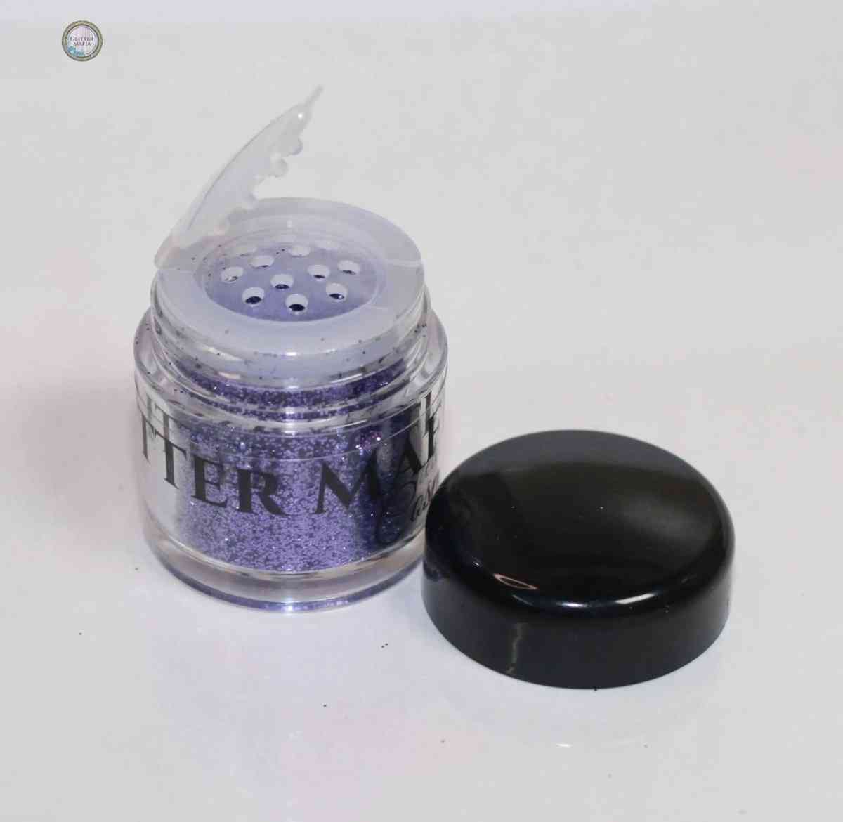 Glitter Mafia Aqua Loose Glitter purple container with black lid and Escape Loose Glitter label