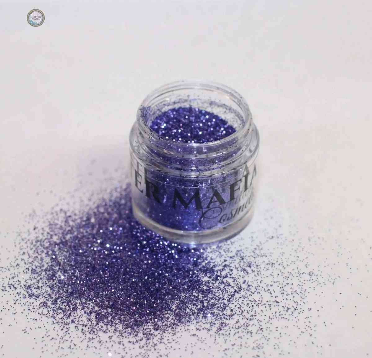 Glitter Mafia Aqua Escape Loose Glitter in vibrant purple shade with scattered sparkles
