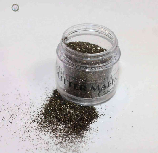 Glitter Mafia container with Forest Green Loose Glitte spilled on white surface