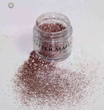 Glitter Mafia blush pink Bubblegum Loose Glitter spilled from a small clear jar on white surface