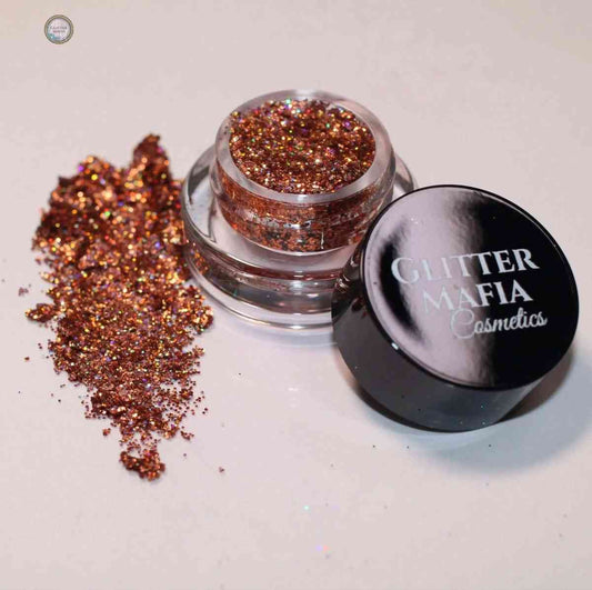 Glitter Mafia Fire Up Pressed Glitter in small jar with loose copper and gold glitter scatter