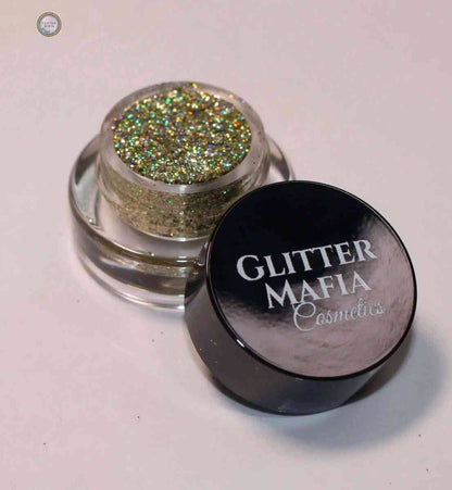 Glitter Mafia Luna Pressed Glitter in mini clear container with black lid showing sparkling gold and green glitter