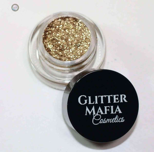 Glitter Mafia Nebula Pressed Glitter in a small clear pot with black lid showing sparkling gold glitter