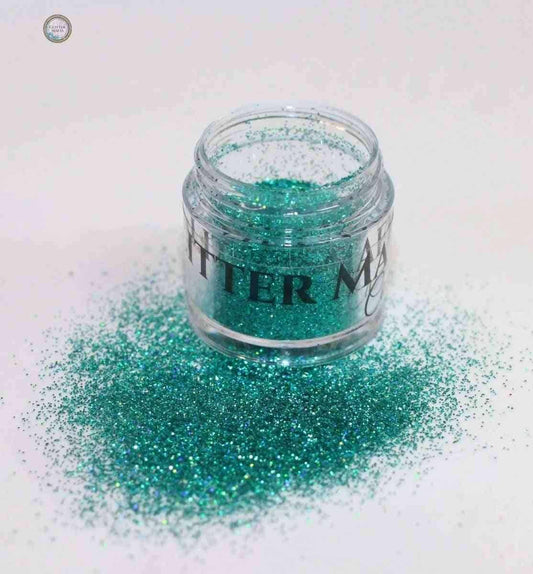 Sparkling teal loose eye glitter in a container