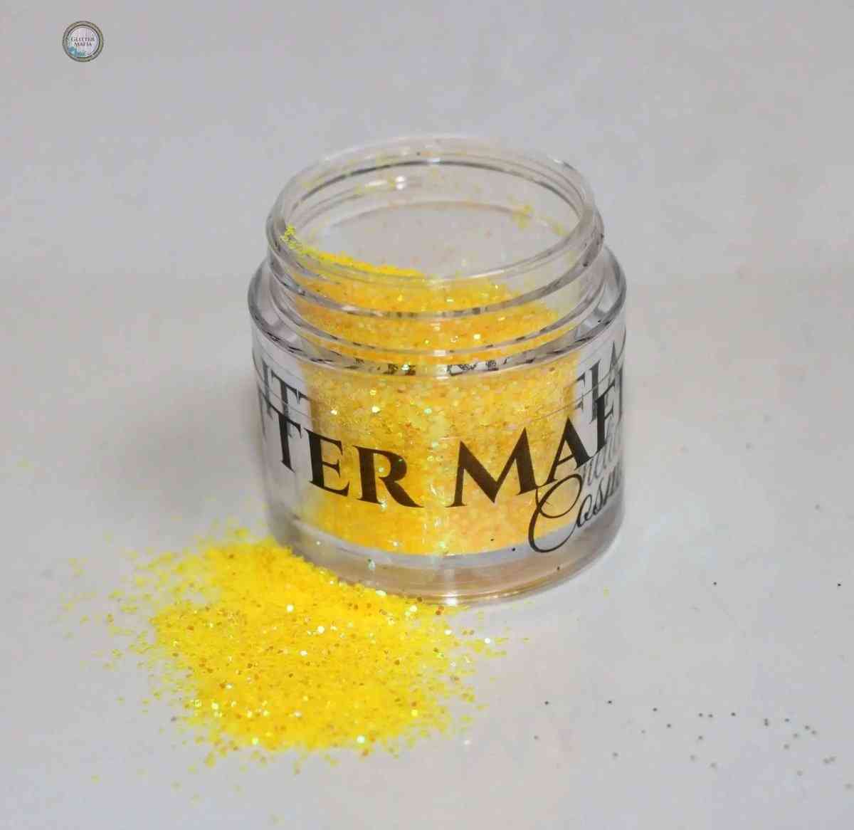 Glitter Mafia Mango Punch Loose Glitter in clear jar with yellow sparkling glitter spilled on surface