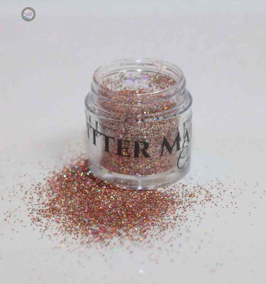 Glitter Mafia Midas Touch Loose Glitter in a clear jar with spilled sparkling gold and holographic glitter