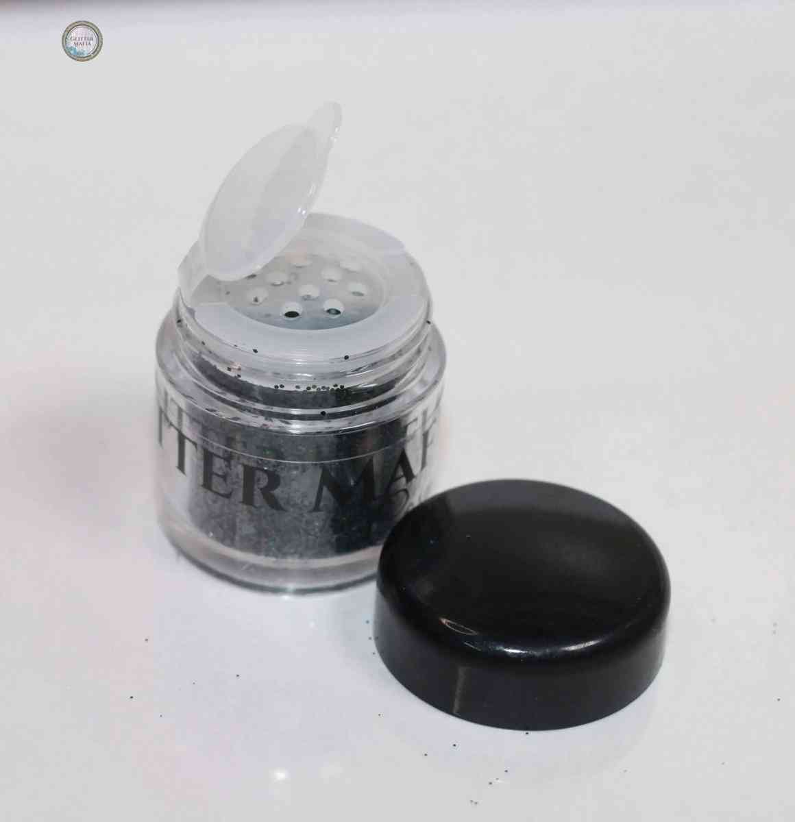 Glitter Mafia Azure Loose Glitter container with black lid removed showing sifter holes and Pretty Green Loose Glitter